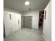 Bright walk-in closet featuring white shelving and cabinets with stylish wood accents and gray floors at 4644 Bay Crest Dr, Tampa, FL 33615