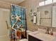 Charming bathroom with coastal decor, featuring a shower with themed curtain and a sink with vanity at 5501 80Th N St # 509, St Petersburg, FL 33709