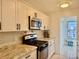 Stylish kitchen with modern appliances, granite countertops, and white cabinets at 5501 80Th N St # 509, St Petersburg, FL 33709