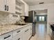 Clean kitchen with granite countertops, stainless steel appliances, and ample cabinet space at 5501 80Th N St # 509, St Petersburg, FL 33709