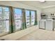 Bright laundry area featuring a washer, dryer, storage shelves, and large windows for natural light at 5501 80Th N St # 509, St Petersburg, FL 33709