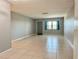 Spacious living room with tile floors and natural light from a window and an adjacent door at 5501 80Th N St # 509, St Petersburg, FL 33709