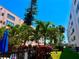 Well-maintained community pool area with mature landscaping and a blue sun umbrella providing shade at 5501 80Th N St # 509, St Petersburg, FL 33709