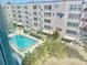 View of the sparkling community pool and lush landscaping from a window at 5501 80Th N St # 509, St Petersburg, FL 33709