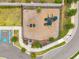 Aerial view of the fenced playground showcases the play equipment with easy access to parking at 5710 Grand Sonata Ave, Lutz, FL 33558