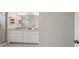 Modern bathroom features dual sinks with white cabinets and granite countertops at 5710 Grand Sonata Ave, Lutz, FL 33558