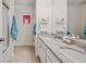 Bathroom features double sinks, stone countertops and tub with shower at 5710 Grand Sonata Ave, Lutz, FL 33558