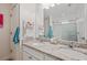 Bathroom featuring double vanity, granite countertops and large mirror at 5710 Grand Sonata Ave, Lutz, FL 33558