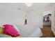 Bedroom has wood floors, a gray bed, and a view into the walk-in closet at 5710 Grand Sonata Ave, Lutz, FL 33558