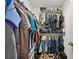 Cozy closet with wire shelving and lots of folded and hanging clothes at 5710 Grand Sonata Ave, Lutz, FL 33558