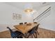 Well-lit dining area with sleek table set, stylish lighting, and stairs adding architectural interest at 5710 Grand Sonata Ave, Lutz, FL 33558