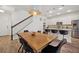 Charming dining area featuring hardwood flooring, modern lighting fixtures, and a breakfast bar in the background at 5710 Grand Sonata Ave, Lutz, FL 33558