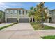 Attractive townhome with a well manicured lawn, beautiful landscaping, and attached two-car garages at 5710 Grand Sonata Ave, Lutz, FL 33558