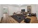 Spacious home gym featuring a weight bench, workout equipment, rubber flooring, and shelving for storage at 5710 Grand Sonata Ave, Lutz, FL 33558