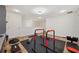 Finished home gym features black rubber flooring, fitness equipment, and white trim at 5710 Grand Sonata Ave, Lutz, FL 33558