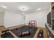 Bright home gym featuring wood-look flooring, wall-mounted TV, workout equipment, and recessed lighting at 5710 Grand Sonata Ave, Lutz, FL 33558