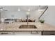 Open-concept kitchen with granite countertops, stainless sink, and seamless flow into the living space at 5710 Grand Sonata Ave, Lutz, FL 33558