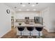 Modern kitchen featuring pendant lighting, white cabinetry, stainless steel appliances, and an island with bar seating at 5710 Grand Sonata Ave, Lutz, FL 33558