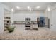 Stylish kitchen featuring a spacious island, white cabinetry, and stainless steel appliances at 5710 Grand Sonata Ave, Lutz, FL 33558