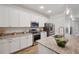 Contemporary kitchen featuring granite countertops, stainless steel appliances, and white cabinets at 5710 Grand Sonata Ave, Lutz, FL 33558