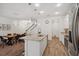 Well-lit kitchen with stainless steel appliances, central island, and an open view to the dining area at 5710 Grand Sonata Ave, Lutz, FL 33558