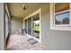 Covered lanai with brick flooring, perfect for enjoying the outdoors at 5710 Grand Sonata Ave, Lutz, FL 33558