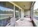 Screened-in lanai overlooking the picturesque pond and landscaping at 5710 Grand Sonata Ave, Lutz, FL 33558
