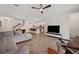 Spacious living room adjacent to a kitchen with an island and modern appliances, with an open concept floorplan at 5710 Grand Sonata Ave, Lutz, FL 33558