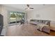 Bright living room featuring tiled floors, a cozy gray sofa, and a sliding glass door to the outdoor area at 5710 Grand Sonata Ave, Lutz, FL 33558
