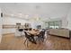 Bright, open-concept with modern kitchen island, dining area, and adjacent living space, perfect for entertaining at 5710 Grand Sonata Ave, Lutz, FL 33558