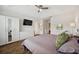Spacious main bedroom showcasing a ceiling fan, hardwood floors, and an ensuite bathroom at 5710 Grand Sonata Ave, Lutz, FL 33558