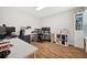 Spacious office features hardwood flooring and multiple workstations for productivity at 5710 Grand Sonata Ave, Lutz, FL 33558
