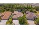 Real estate aerial of home with a pond view, landscaping, and neutral color roof at 6203 34Th E Ct, Ellenton, FL 34222