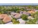 Aerial view of the residential neighborhood with lush tree coverage and water views at 6203 34Th E Ct, Ellenton, FL 34222