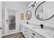 Modern bathroom boasts double sinks, stylish mirrors, and a door to the outside at 6203 34Th E Ct, Ellenton, FL 34222