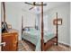 Comfortable bedroom with a four-poster bed, ceiling fan, and elegant furnishings at 6203 34Th E Ct, Ellenton, FL 34222