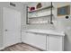 Bright butler's pantry with custom cabinets, countertop, stylish shelving and modern hardware at 6203 34Th E Ct, Ellenton, FL 34222