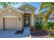Inviting front entrance showcasing a stylish blue door and well-maintained landscaping at 6203 34Th E Ct, Ellenton, FL 34222