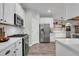 Modern kitchen featuring stainless steel appliances, sleek white cabinetry, and durable countertops for easy cooking at 6203 34Th E Ct, Ellenton, FL 34222