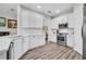 Bright, spacious kitchen with stainless steel appliances, white cabinetry, and a stylish backsplash at 6203 34Th E Ct, Ellenton, FL 34222
