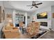 Bright living room with floral patterned furniture, fireplace, and sliding doors to the outdoor pool area at 6203 34Th E Ct, Ellenton, FL 34222
