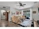 Comfortable living room featuring a ceiling fan, plush furniture, and sliding glass doors leading to the pool at 6203 34Th E Ct, Ellenton, FL 34222