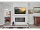 Cozy living room features a modern fireplace, mounted TV, and elegant decor, providing a comfortable space at 6203 34Th E Ct, Ellenton, FL 34222