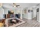Open-concept living area features modern decor, hardwood flooring, and a cozy fireplace at 6203 34Th E Ct, Ellenton, FL 34222