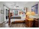 Spacious main bedroom featuring a four-poster bed, ceiling fan, and access to a private outdoor patio at 6203 34Th E Ct, Ellenton, FL 34222