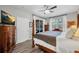 Bright main bedroom featuring a four-poster bed, ceiling fan, and access to a private outdoor patio at 6203 34Th E Ct, Ellenton, FL 34222