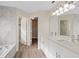 A bathroom with marble countertops, double sinks, and access to the tub and walk-in closet at 6501 Appaloosa Dr, Tampa, FL 33625