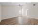 A bright bedroom with wood look flooring, a ceiling fan, and an exterior view at 6501 Appaloosa Dr, Tampa, FL 33625