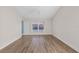 A neutral bedroom with a ceiling fan, wood-look flooring, and an exterior view at 6501 Appaloosa Dr, Tampa, FL 33625