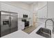 Well-equipped kitchen boasting white cabinetry, stainless steel appliances, and wood-look floors at 6501 Appaloosa Dr, Tampa, FL 33625
